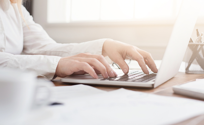 side view of woman's hand on keyboard