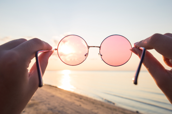 Rose colored glasses looking at a beach scene