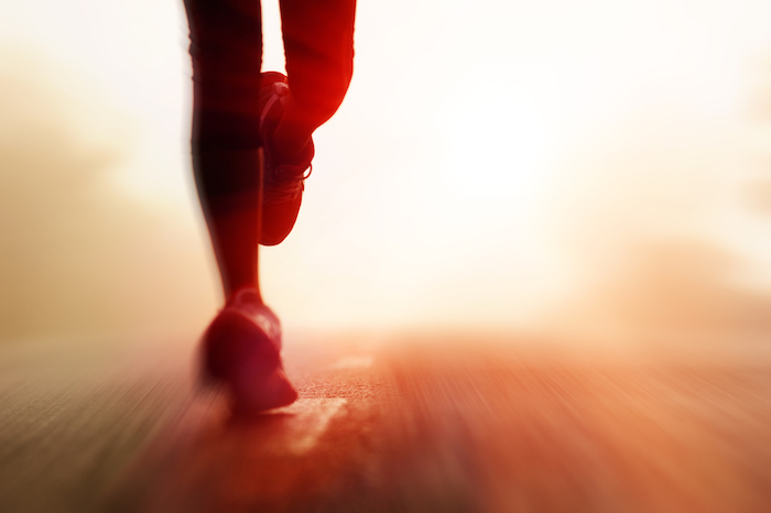 runners feet on road