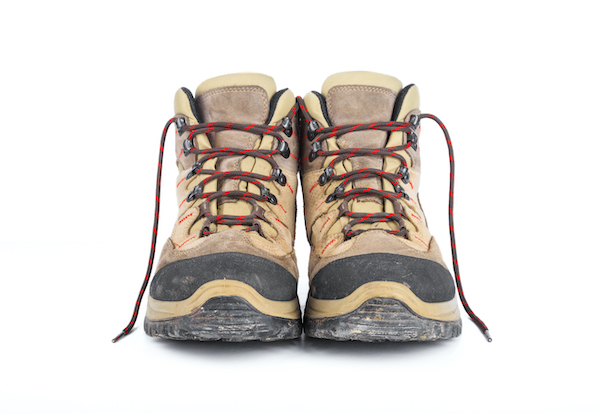 Dirty hiking boots on a white background