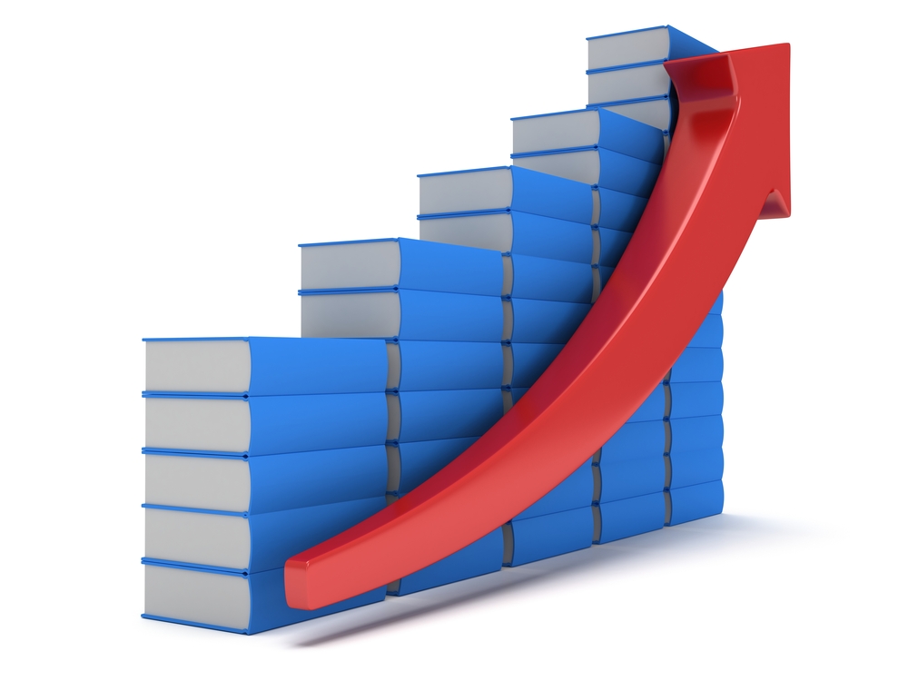 blue books arrayed like a bar chart, with a red arrow indicated growth