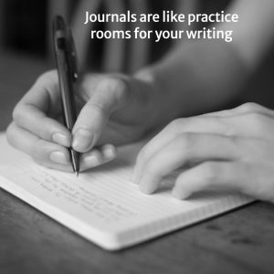 Hands writing in journal