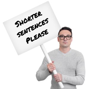 Man holding sign saying "Shorter sentences please"