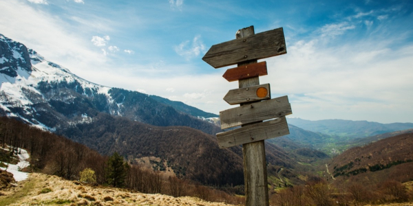 Wooden sign post in the mountains.