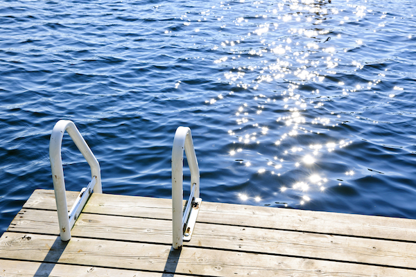 Dock and ladder on a sparkling lake in summer