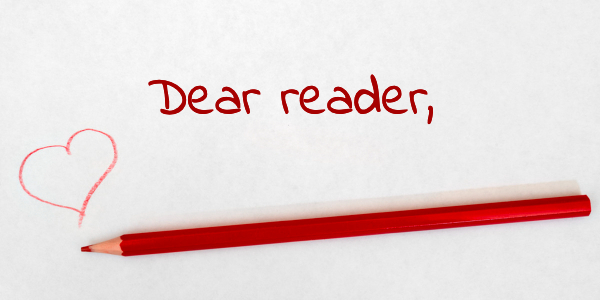 Red pencil on white paper with heart and words Dear Reader