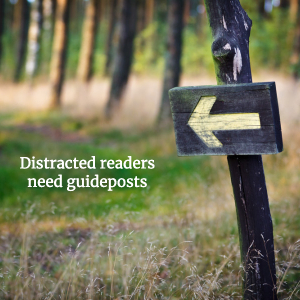 Sign along a trail in the forest. Words: Distracted readers need guideposts. Depositphoto