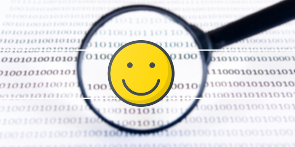 Magnifying glass over code, showing a smiley face
