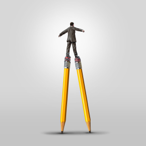 Man walking on giant pencils as stilts