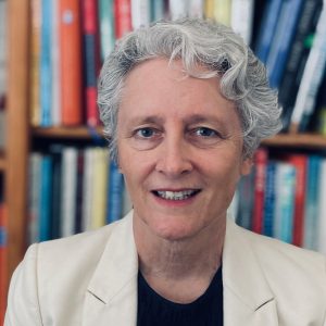 Anne Janzer in front of bookcase