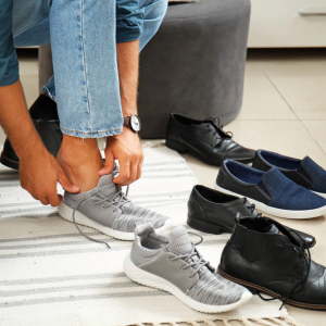 man trying on different pairs of shoes