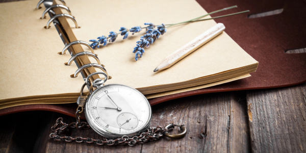 vintage notebook, watch and pencil