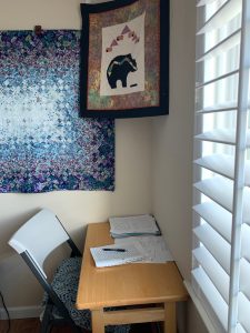 small table in corner with pen and paper

